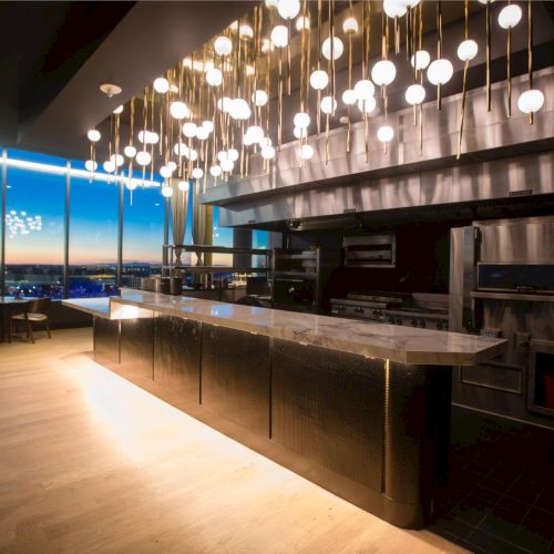 A long bar with stools and shelves of bottles, warm lighting, and a calm, cozy vibe.