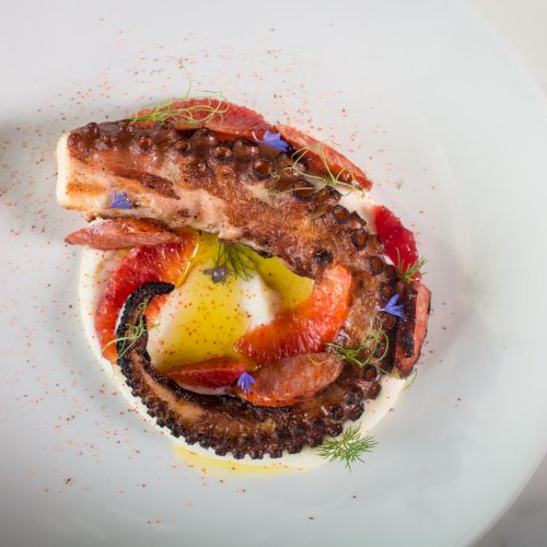 A close-up of a small, round dish with a sunny-side-up egg topping in a brown sauce, garnished with herbs. ending.